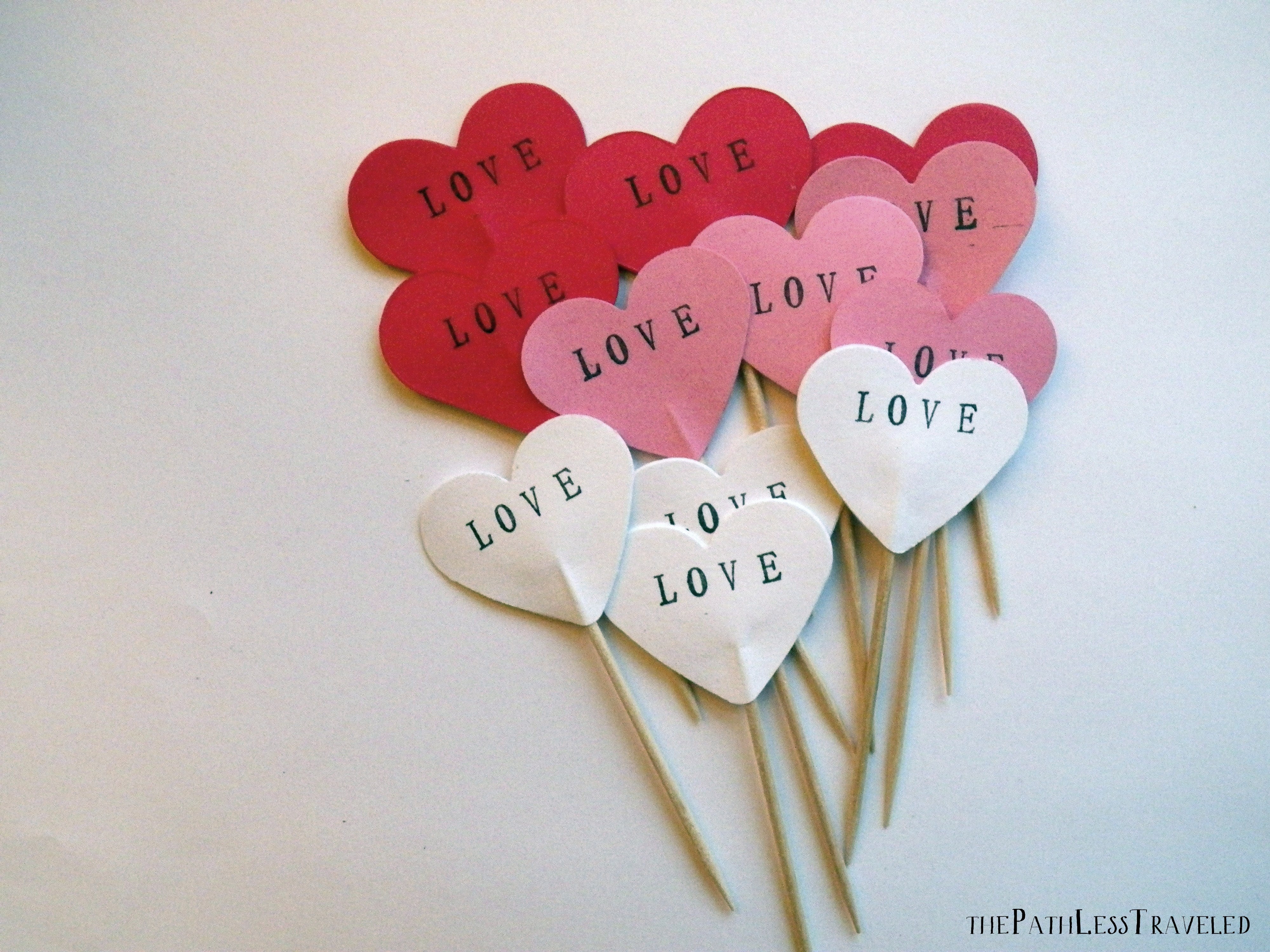 A romantic set of 12 heart cupcake toppers in your choice of red, pink, white or a mix of all three